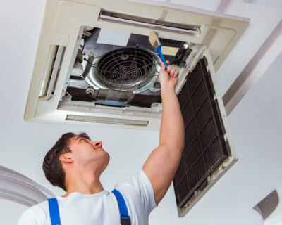 worker-repairing-ceiling-air-conditioning-unit